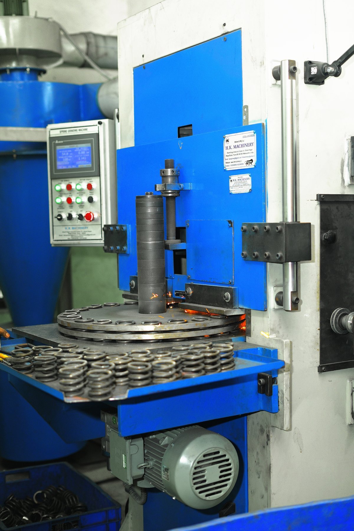 Precision spring coiling machinery on the factory floor